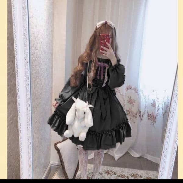 girl taking photo in the mirror wearing a cute black kawaii dress