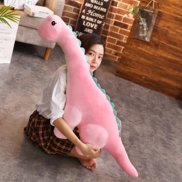 girl cuddling with large Long Neck Dinosaur Stuffed Animal