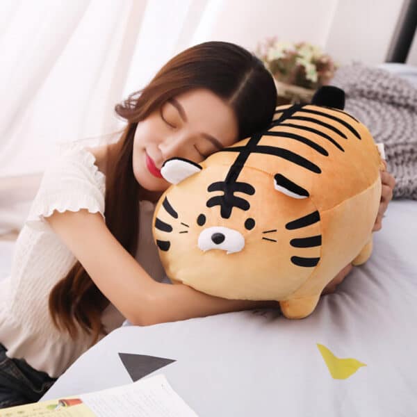 tiger stuffed animal cuddling with girl