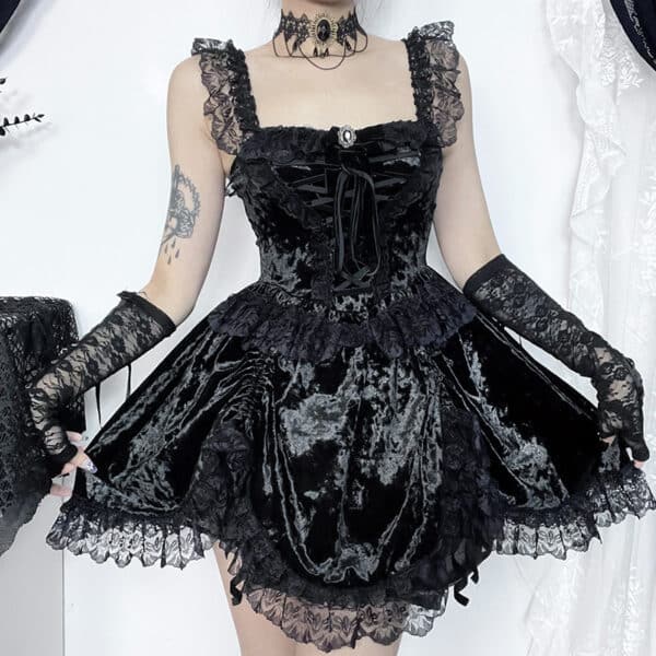 goth girl holding bottom part of black Velvet Gothic Mini Dress