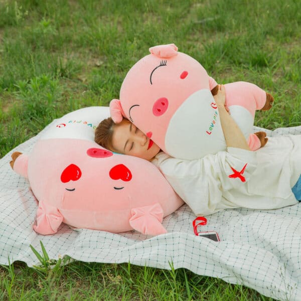 girl cuddling with 2 Pig Plush Toys