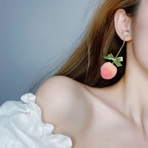 bow Sugar-Coated Peach Earrings on model
