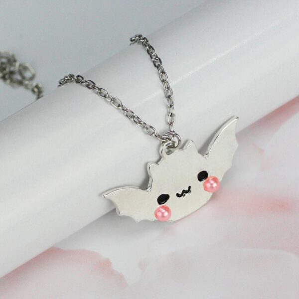 Shiny Silver Bat Necklace on table