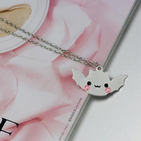 Shiny Silver Bat Necklace with book background
