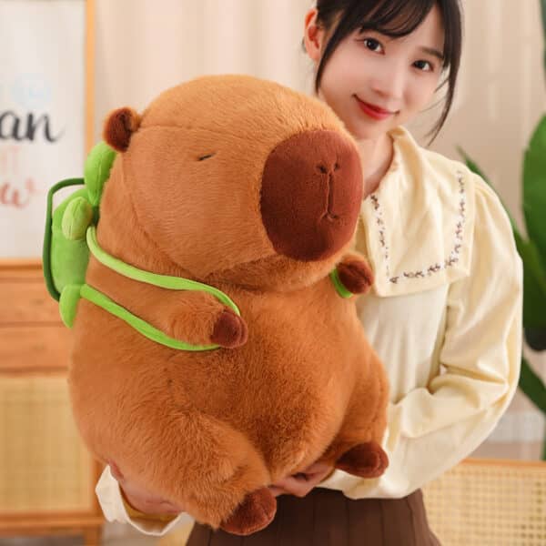 capybara plush toy held by girl
