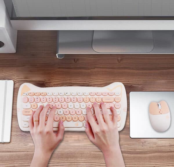 cute girl typing on adorable pink keyboard